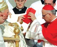 Cardinal George receives the red hat from Pope John Paul II